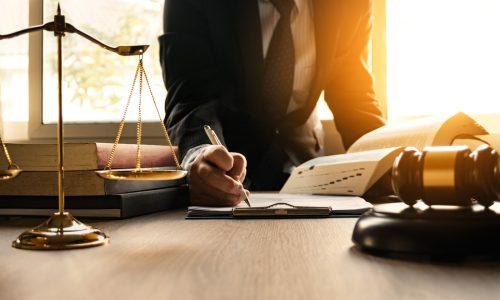 Male lawyer working with contract papers and wooden gavel on tabel in courtroom. justice and law ,attorney, court judge, concept.